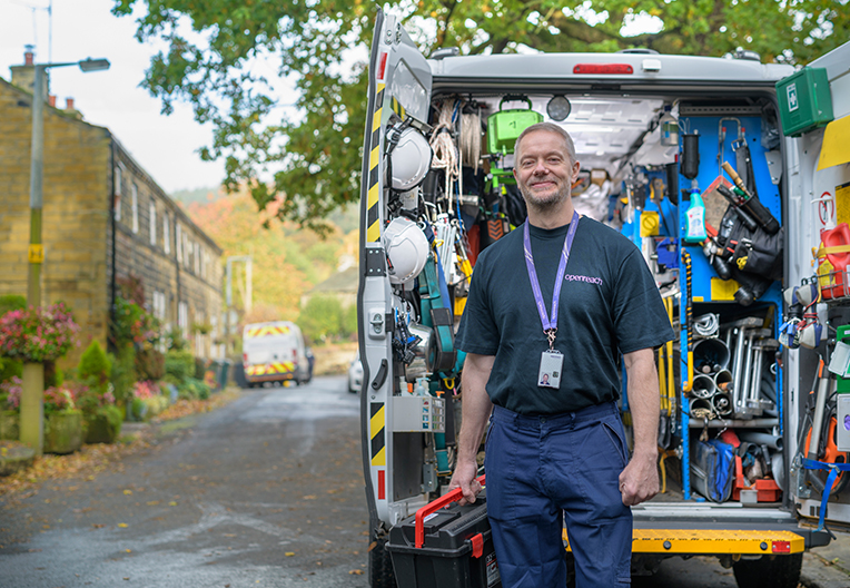Engineer standing in front of van with equipments