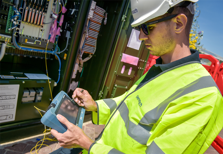Image of engineer using test equipment on a cabinet